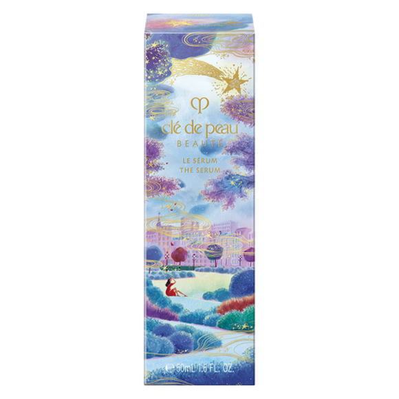 Photo of the 26 AW Holiday Collection limited-edition THE SERUM outer box. The package features an illustration of a woman looking up at a town under a starry night sky with purple clouds, decorated with a large gold shooting star at the top.